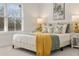 Bedroom showcasing a bed with decorative pillows and a yellow throw blanket near a bright window at 4826 Floydwood Ln, Mableton, GA 30126