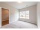 Bright bedroom featuring plush carpet, double door closet, and large window at 4826 Floydwood Ln, Mableton, GA 30126