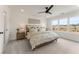 Primary bedroom features a decorative ceiling fan, carpeted floors and a large window at 4826 Floydwood Ln, Mableton, GA 30126