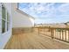 Back deck featuring a natural wood-stained deck floor and a painted white house exterior at 4826 Floydwood Ln, Mableton, GA 30126