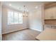 Cozy dining area featuring modern lighting, a large window, and seamless access to the kitchen at 4826 Floydwood Ln, Mableton, GA 30126