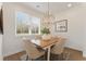 Bright dining room features modern chandelier and natural light from the window overlooking the front yard at 4826 Floydwood Ln, Mableton, GA 30126