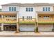 Rear view of townhomes showing wooden decks and garages beneath at 4826 Floydwood Ln, Mableton, GA 30126