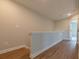 Upstairs hallway features hardwood floors and white railings at 4826 Floydwood Ln, Mableton, GA 30126