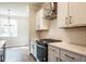 Well-lit kitchen features new appliances, decorative tile backsplash and white countertops at 4826 Floydwood Ln, Mableton, GA 30126