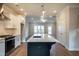 Modern kitchen featuring stainless steel appliances, island with quartz counters, and open layout at 4826 Floydwood Ln, Mableton, GA 30126