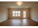 Open-concept living room with light-colored walls, hardwood flooring, and access to outdoor deck at 4826 Floydwood Ln, Mableton, GA 30126