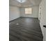 Bedroom with hard surface flooring, tray ceiling, and lots of natural light at 5055 Promenade Sw Dr, Atlanta, GA 30331