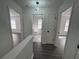 Hallway with views to three rooms, featuring hard surface flooring and updated lighting at 5055 Promenade Sw Dr, Atlanta, GA 30331