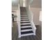 Elegant staircase with dark wood treads and white risers in a bright, modern interior at 5055 Promenade Sw Dr, Atlanta, GA 30331