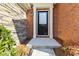 Close-up of the front door with brick and stone accents, providing a welcoming entrance at 5729 Evadale Trce # 6, Mableton, GA 30126