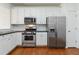 Well-equipped kitchen featuring stainless steel appliances, white cabinetry, and dark countertops at 5729 Evadale Trce # 6, Mableton, GA 30126