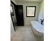 Bathroom featuring a standalone tub and natural light from the window at 2087 Blackberry Ln, Auburn, GA 30011