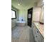 Bright bathroom with a soaking tub and a large granite countertop vanity at 2087 Blackberry Ln, Auburn, GA 30011