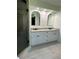 Spacious bathroom featuring double vanities and arched mirrors at 2087 Blackberry Ln, Auburn, GA 30011