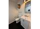 Elegant powder room with a modern vanity and black tile flooring at 2087 Blackberry Ln, Auburn, GA 30011