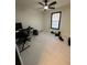Bedroom with contemporary gray walls, ceiling fan and bright window is staged as a functional office space at 2087 Blackberry Ln, Auburn, GA 30011