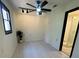 Bright bedroom with a modern ceiling fan, track lights, and a view from the window at 2087 Blackberry Ln, Auburn, GA 30011