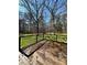 Enjoy the weather and greenery views from this wood deck with black iron railings on a sunny day at 2087 Blackberry Ln, Auburn, GA 30011