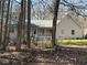 Inviting single-story house with a cozy front porch nestled among mature trees at 2087 Blackberry Ln, Auburn, GA 30011