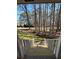 View from the covered front porch showcases the peaceful, tree-lined surroundings at 2087 Blackberry Ln, Auburn, GA 30011