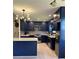 Beautiful kitchen with navy cabinets, quartz counters, stainless appliances, and modern light fixture at 2087 Blackberry Ln, Auburn, GA 30011