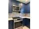 Close-up of the newly renovated kitchen featuring stainless steel appliances and stylish gray tile backsplash at 2087 Blackberry Ln, Auburn, GA 30011