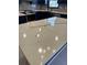 A close up on an amazing quartz kitchen island with gray and black marble detailing at 2087 Blackberry Ln, Auburn, GA 30011
