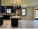 Updated kitchen boasts navy cabinets, stainless appliances, quartz counters, and stylish light fixtures at 2087 Blackberry Ln, Auburn, GA 30011