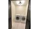 Bright laundry area featuring front load washer and dryer with overhead lighting at 2087 Blackberry Ln, Auburn, GA 30011