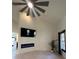 Sunlit living room with fireplace, tv, ceiling fan, and views into other rooms at 2087 Blackberry Ln, Auburn, GA 30011