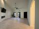 Spacious living room with a modern fireplace, sleek ceiling fan, and large windows for natural light at 2087 Blackberry Ln, Auburn, GA 30011