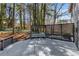 Back deck with a bench and privacy trellis with a view of the wooded backyard at 4112 Gregory Manor Sw Cir, Smyrna, GA 30082