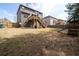Spacious backyard with a play set and a two-tiered deck, perfect for outdoor activities and relaxation at 784 Sunset Down Ct, Loganville, GA 30052