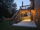 Spacious backyard with wooden deck, covered patio with string lights, playground, and basketball hoop at 784 Sunset Down Ct, Loganville, GA 30052