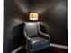 Comfortable reading nook with an elegant upholstered chair and stylish lighting at 784 Sunset Down Ct, Loganville, GA 30052