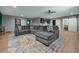 Spacious bonus room with a large sectional, wood floors, and a bar area; perfect for entertaining at 784 Sunset Down Ct, Loganville, GA 30052