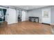 Spacious bonus room with wood floors, sliding barn doors to an office, and access to an exterior door at 784 Sunset Down Ct, Loganville, GA 30052