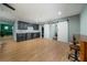 Bonus space featuring hardwood floors, a bar area with black cabinetry and a herring bone backsplash, and barn doors at 784 Sunset Down Ct, Loganville, GA 30052