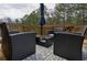 Outdoor deck area with comfortable seating, a table, and an umbrella, offering a relaxing space at 784 Sunset Down Ct, Loganville, GA 30052