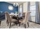 Elegant dining room featuring a large table, six chairs, stylish lighting, and large windows at 784 Sunset Down Ct, Loganville, GA 30052