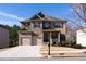 A two-story home features a two-car garage, a stone and brick facade, well-maintained landscaping and a concrete driveway at 784 Sunset Down Ct, Loganville, GA 30052