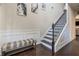 Elegant foyer with staircase, wainscoting, and hardwood floors at 784 Sunset Down Ct, Loganville, GA 30052