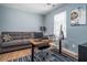 Comfortable home office featuring a modern desk setup and a cozy couch for relaxation at 784 Sunset Down Ct, Loganville, GA 30052