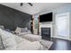Inviting living room with fireplace, stylish accent wall and plush seating area at 784 Sunset Down Ct, Loganville, GA 30052