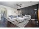 Comfortable living room with a large sectional sofa, stylish decor, and dark hardwood floors at 784 Sunset Down Ct, Loganville, GA 30052
