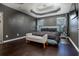 Main bedroom features a tray ceiling, dark walls, and a view to the backyard at 784 Sunset Down Ct, Loganville, GA 30052