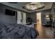 Spacious main bedroom boasts dark walls, a tray ceiling, and a view to the office and bathroom at 784 Sunset Down Ct, Loganville, GA 30052
