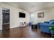 Bright playroom with hardwood floors, blue sofa, and TV at 784 Sunset Down Ct, Loganville, GA 30052