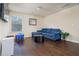 Bright playroom with hardwood floors, blue sofa, and table at 784 Sunset Down Ct, Loganville, GA 30052